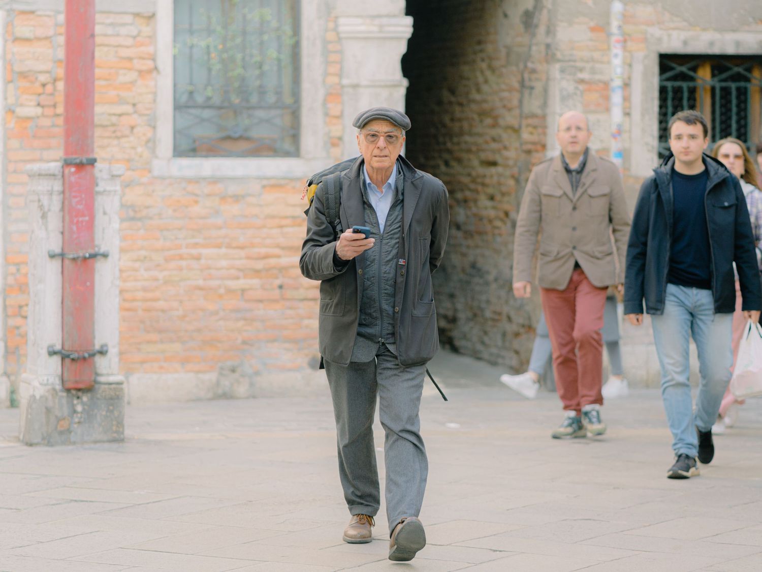 An old man walking with nice clothes in Venice Italy