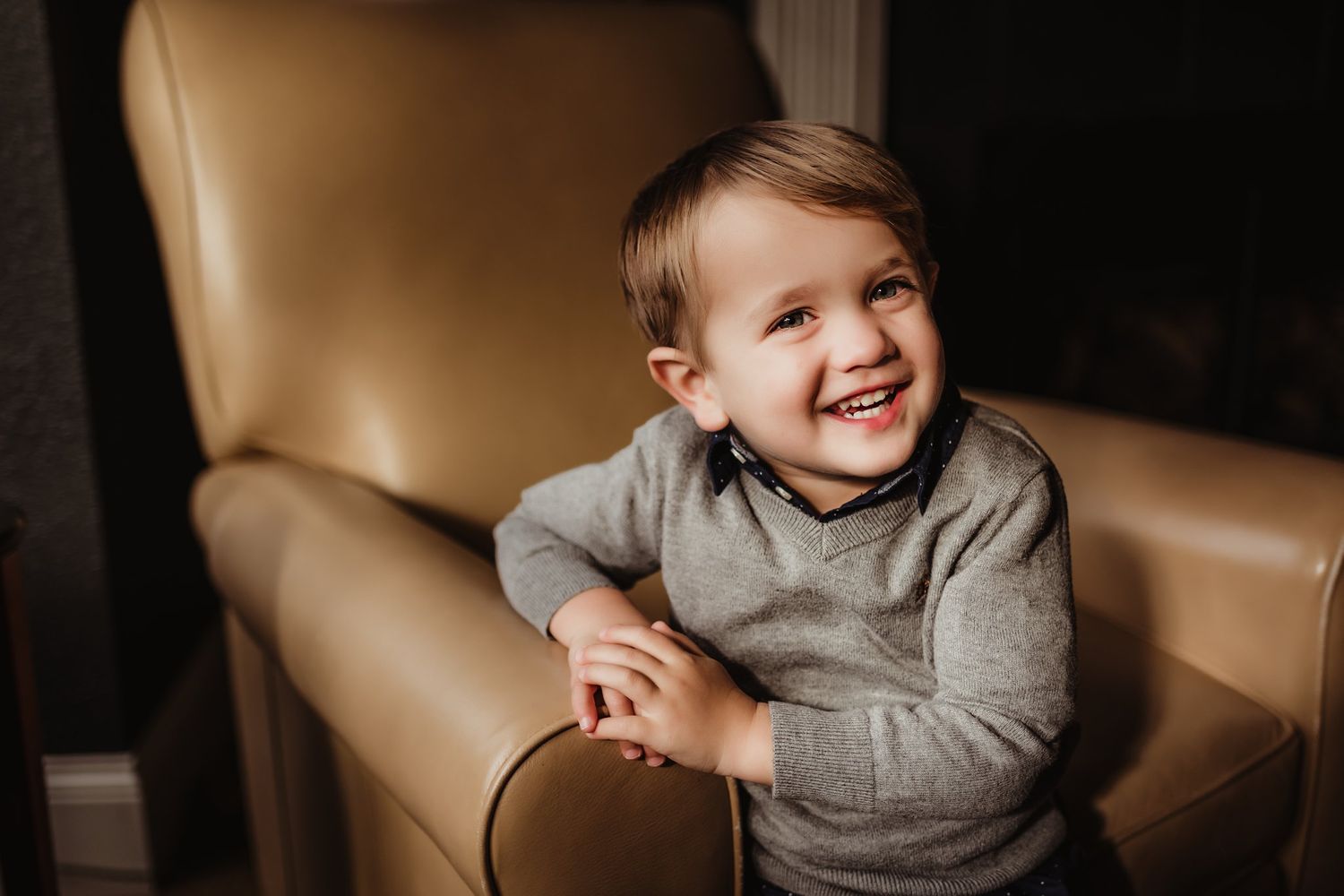 A heartwarming candid moment captured on a leather chair with natural lighting.