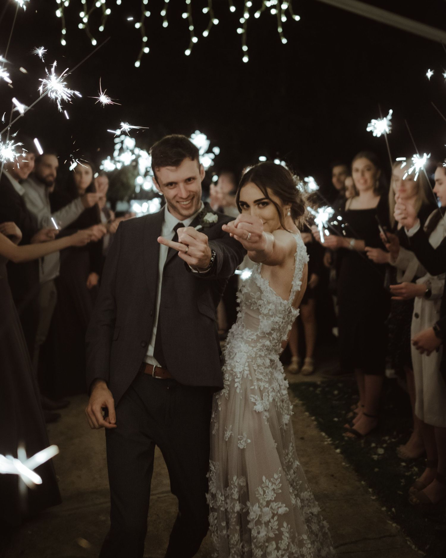 bride and groom showing rings with wedding guest behind them during wedding, captured by Wouter Kleynhans Photography