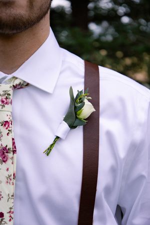 Groom detail picture with boutonniere with trees behind him at Orland, California Wedding