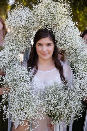 Bride with baby's breath bouquets around her during bridal portraits at Orland, California Wedding