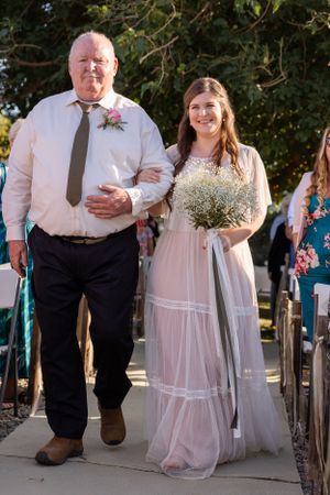 Bride and father of the bride walking down the aisle during Orland, California Wedding with tree behind them