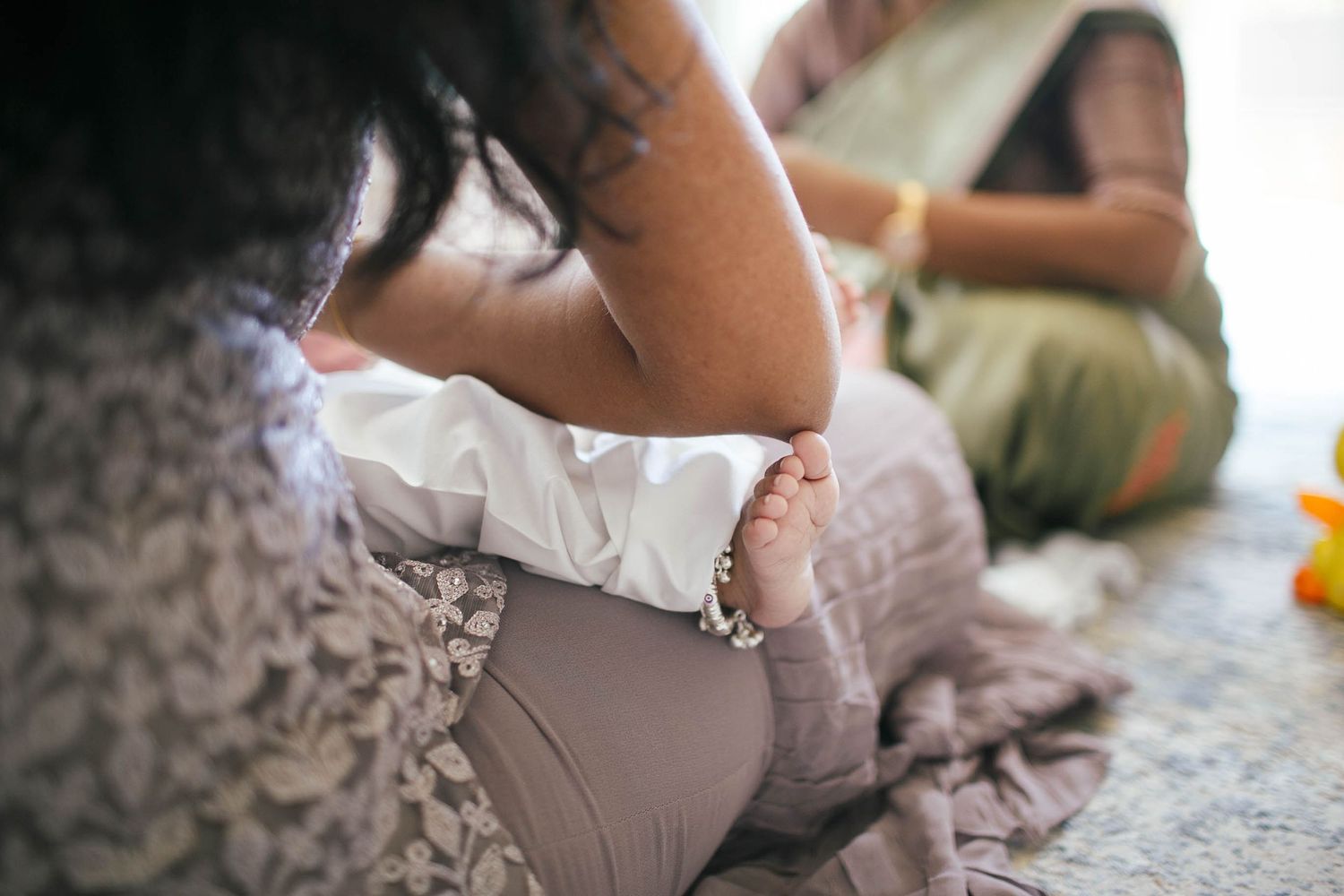 Everett newborn session: A mother changes her son's clothes during an in-home lifestyle photo session