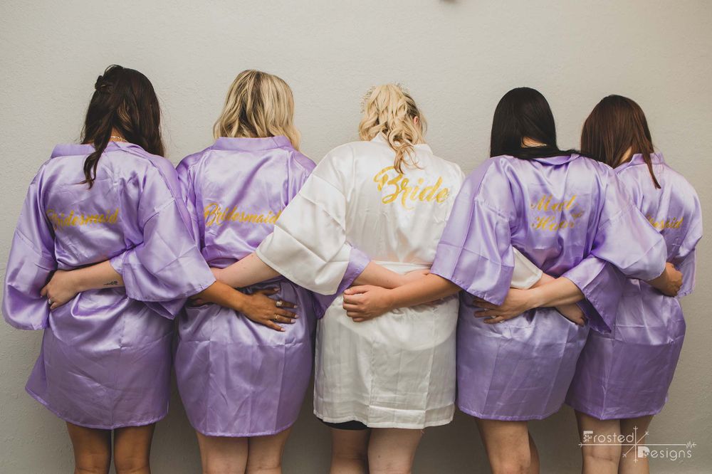 Bridesmaids in their bridal robes before wedding day.