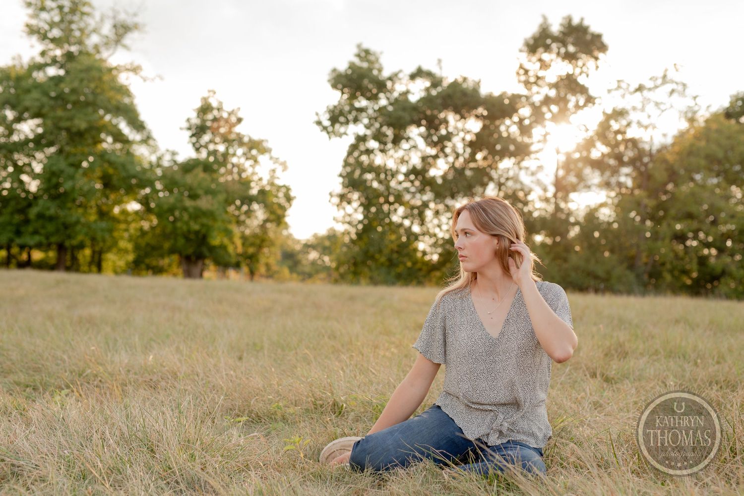Relaxed outdoor photography session in a golden field at sunset.