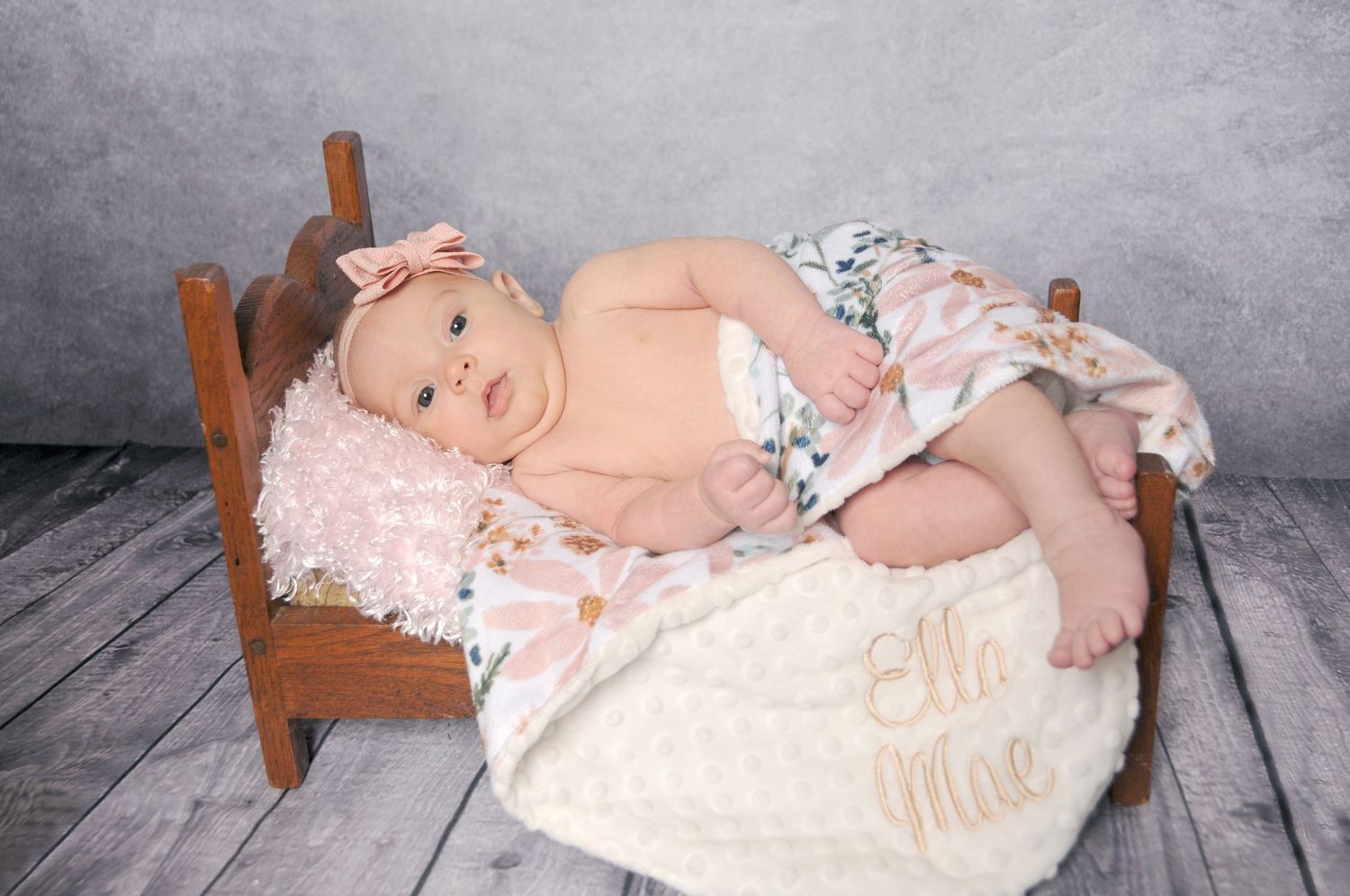Newborn girl in prop bed