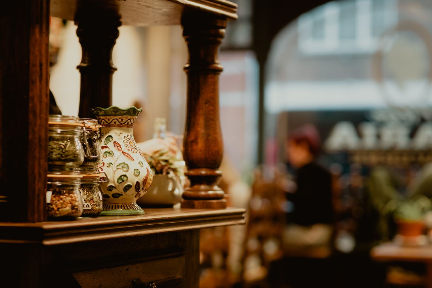 Vintage decorative items on wooden shelves in a dimly lit rustic interior.