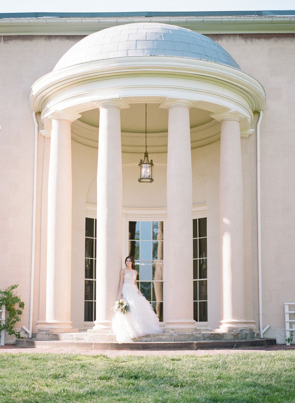 Classic white domed pavilion with columns creating an elegant wedding ceremony backdrop.