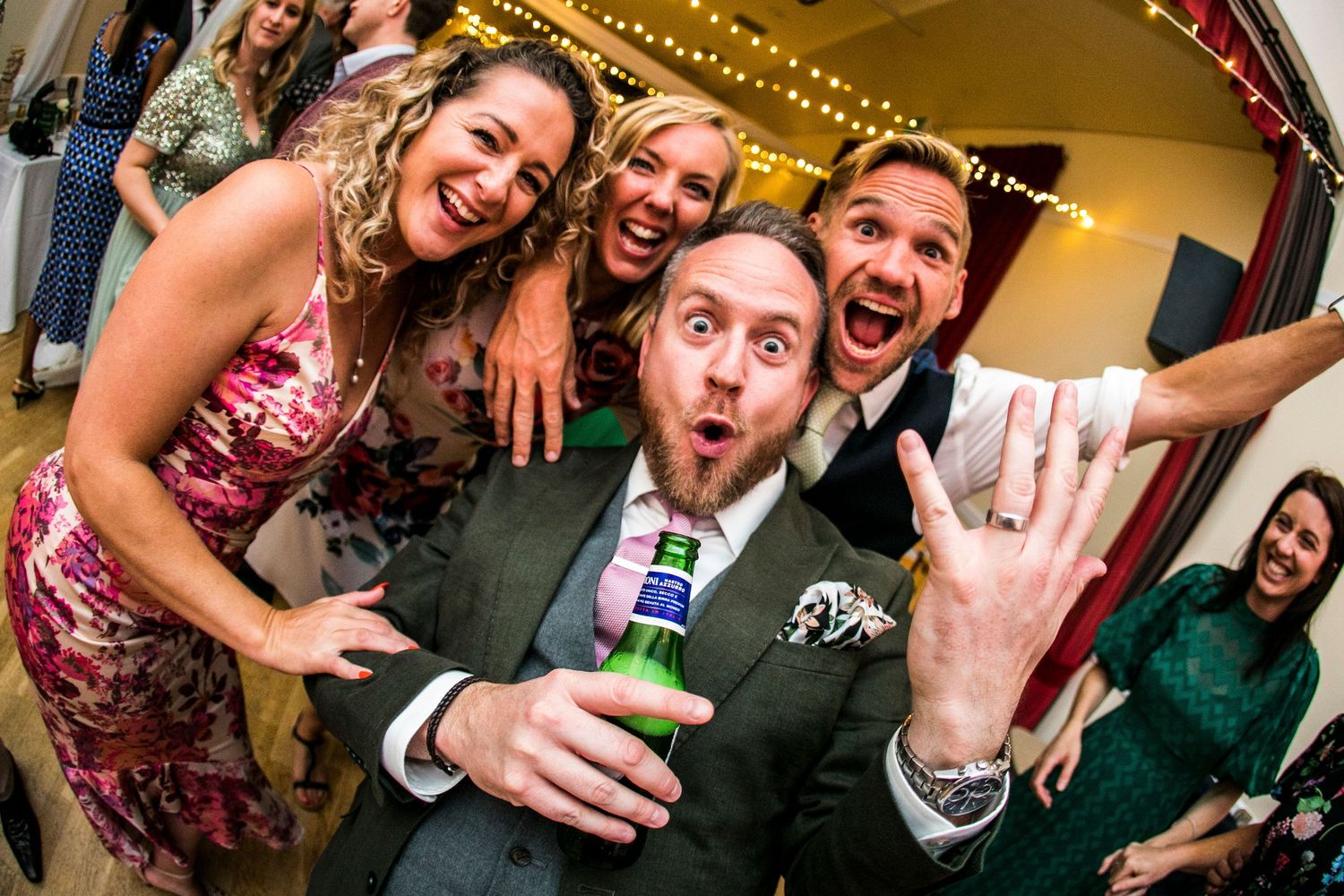 Party guests enjoying drinks and celebrations at a festive event.