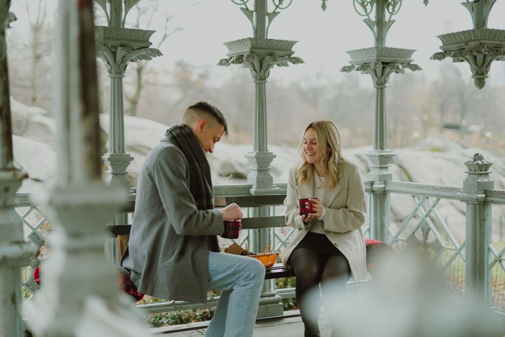 A couple sits close together on a bench with star-shaped decorations visible above.