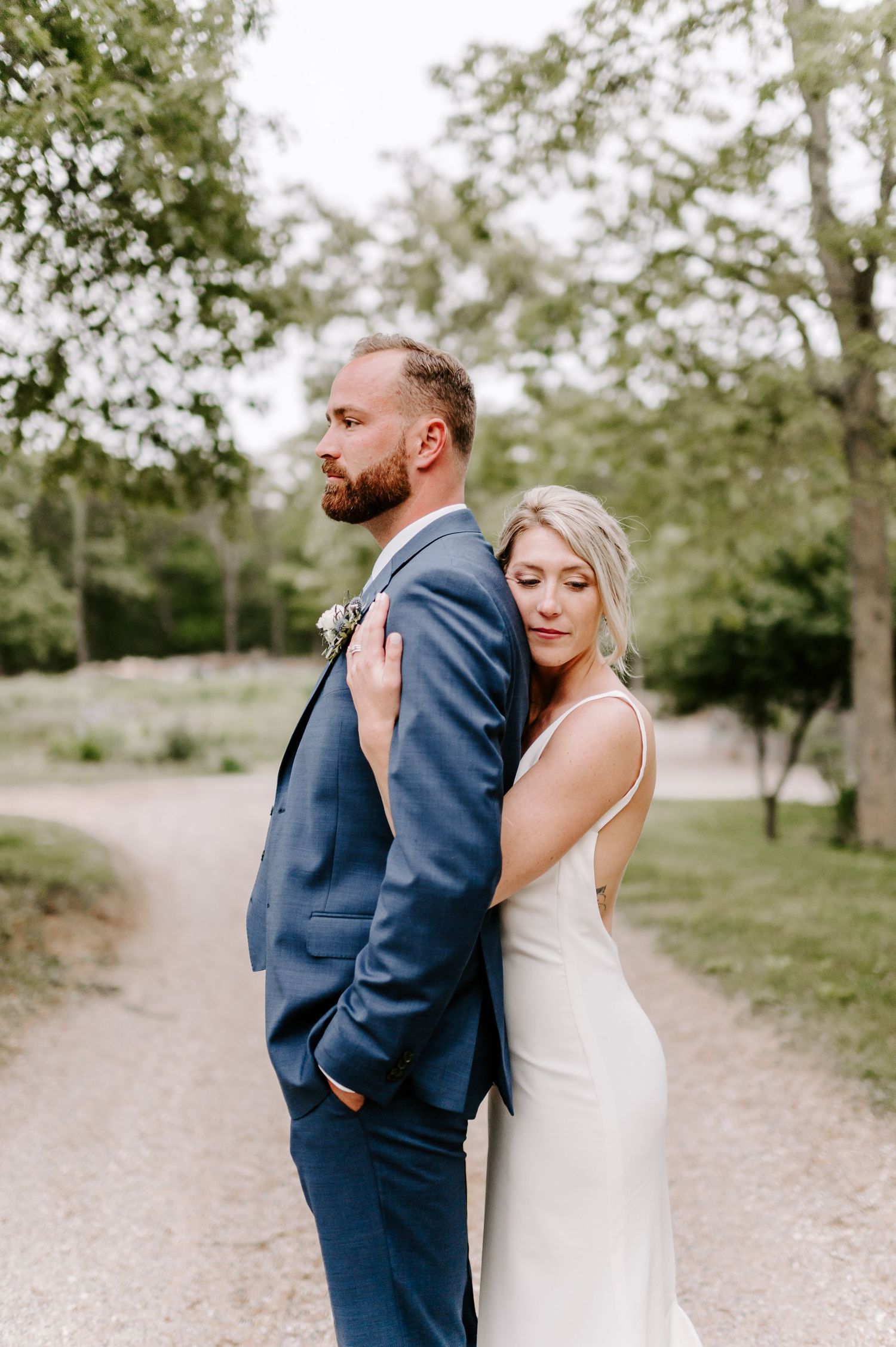 A tender moment between newlyweds on a scenic outdoor path.