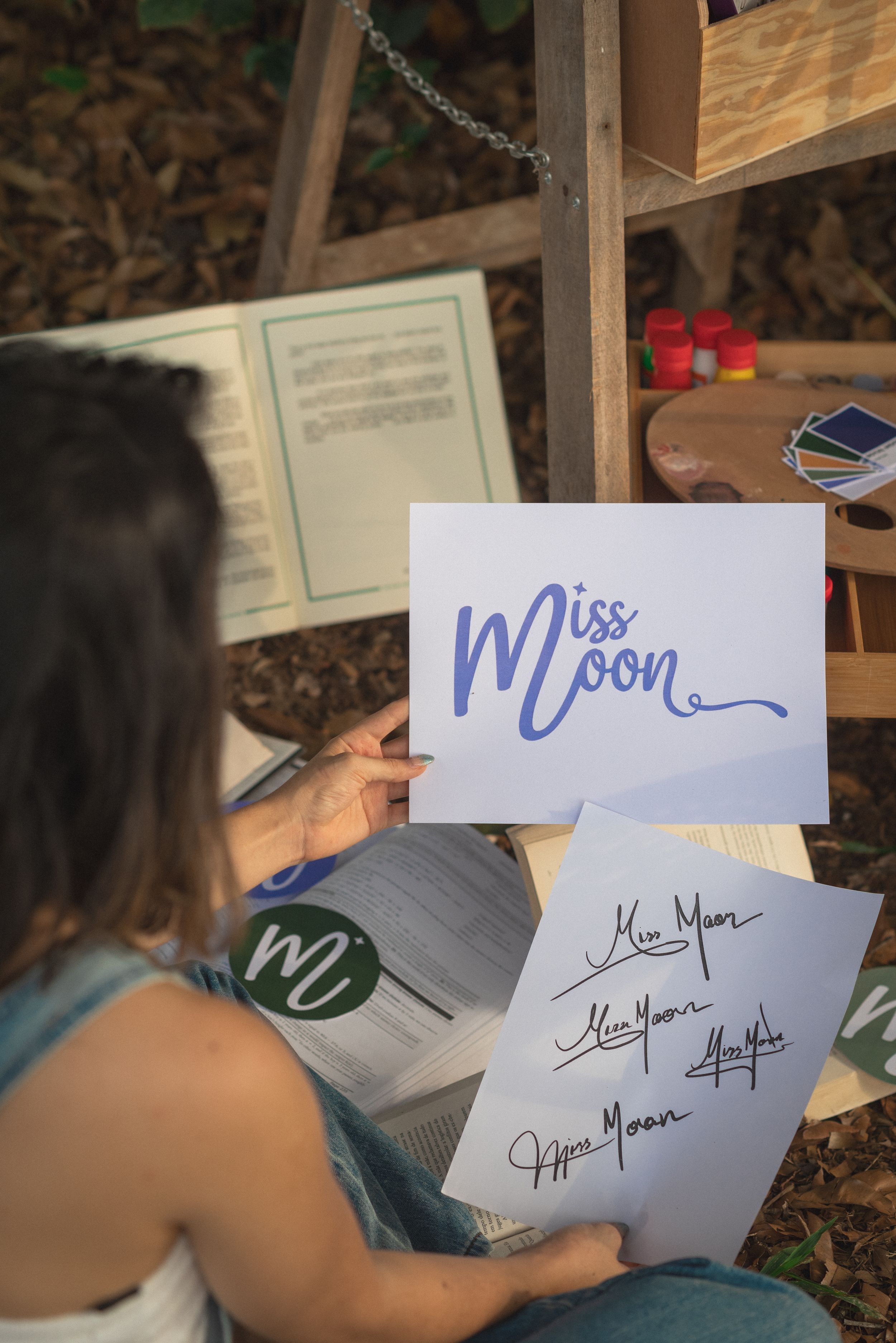 Blue Miss Moon logo design signature and branding concepts on white paper.