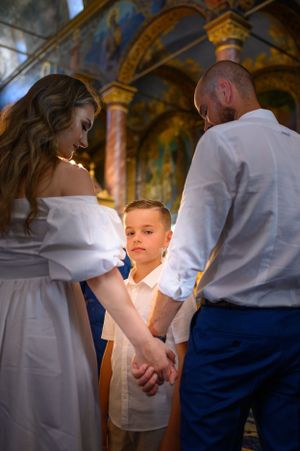 Intimate church ceremony with ornate golden decorations and frescoes.