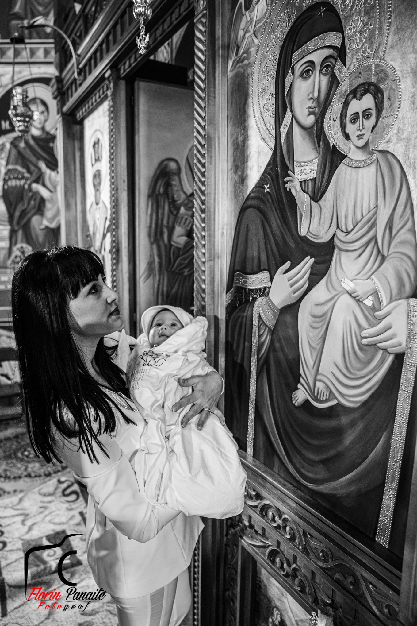 Black and white photo of religious icons and artwork in church setting.
