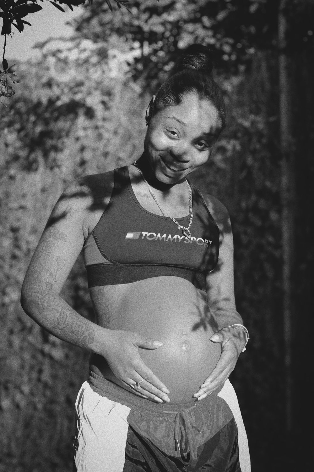 A series of black and white photographs showing a pregnant person's belly in different stages of pregnancy.