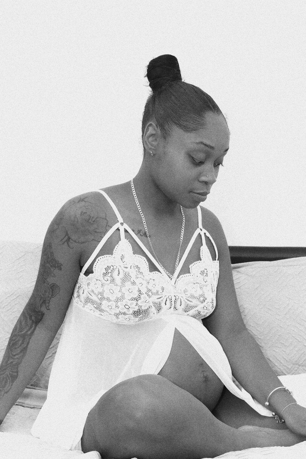 Artistic black and white boudoir photography featuring delicate white lace details.
