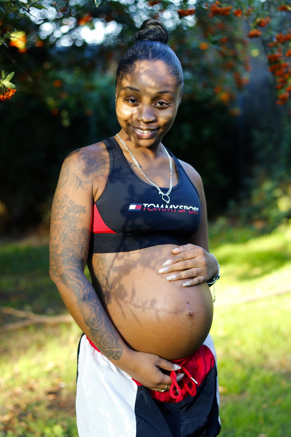 A series of pregnancy progression photos showing a growing baby bump against a natural outdoor background.
