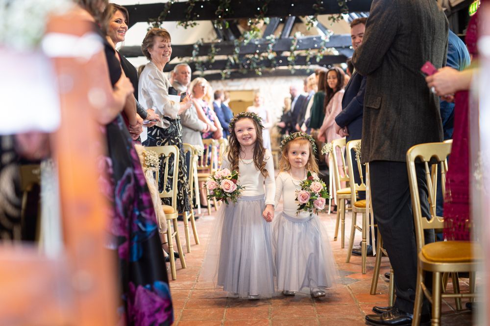 Wedding reception dance floor filled with guests and bridesmaids in gray dresses.