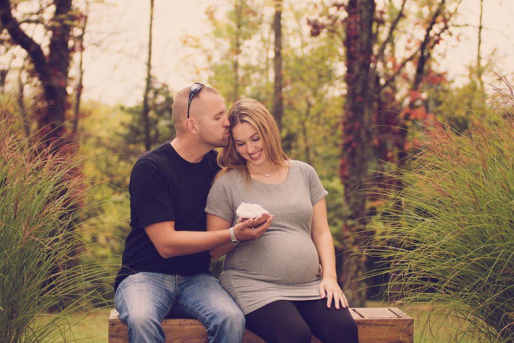 Outdoor photo of pregnant woman and her husband taken during a maternity session by professional maternity photographer in East Tennessee