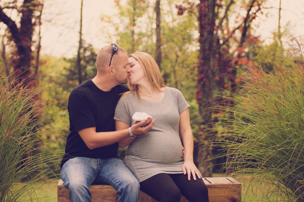 Outdoor photo of pregnant woman and her husband taken during a maternity session by professional maternity photographer in East Tennessee