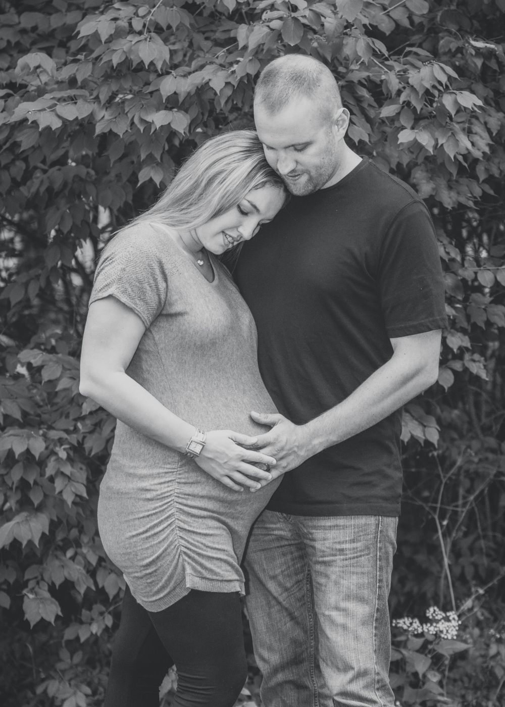 Outdoor photo of pregnant woman and her husband taken during a maternity session by professional maternity photographer in East Tennessee