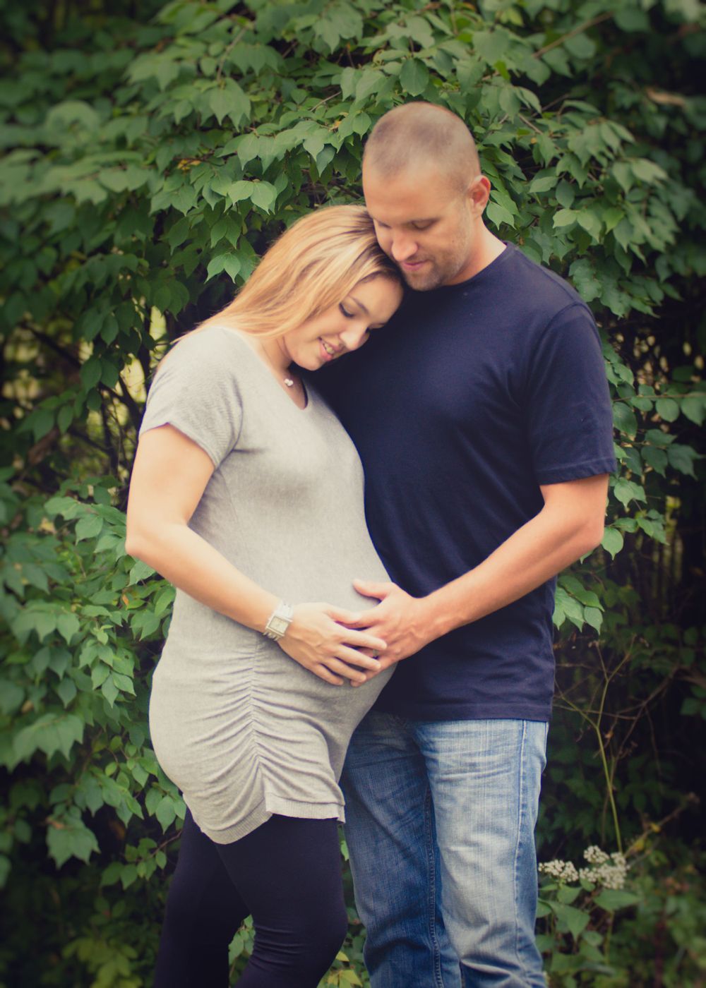 Outdoor photo of pregnant woman and her husband taken during a maternity session by professional maternity photographer in East Tennessee