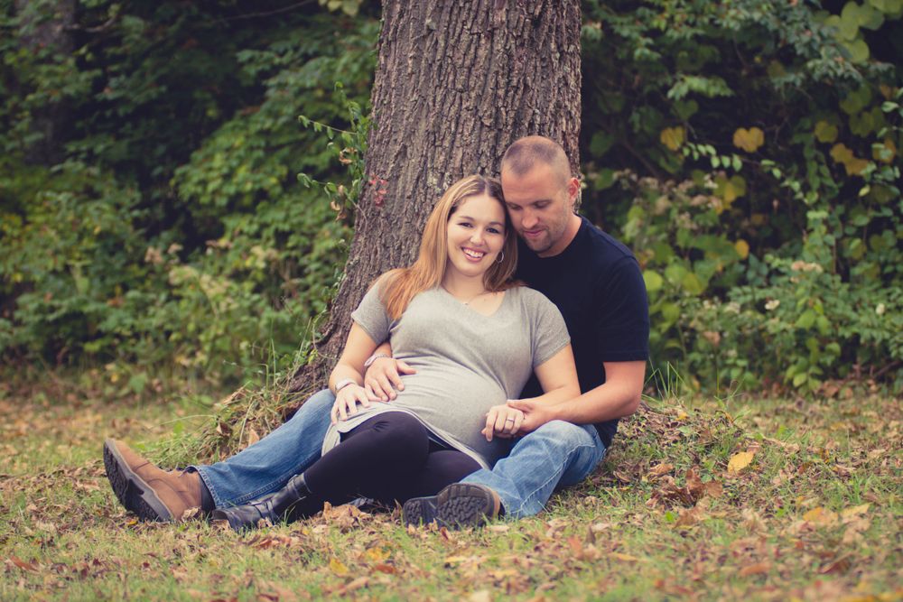 Outdoor photo of pregnant woman and her husband taken during a maternity session by professional maternity photographer in East Tennessee