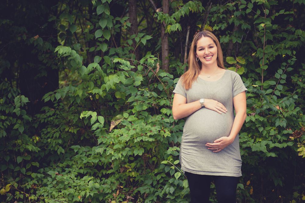 Outdoor photo of pregnant woman in the woods during a maternity session by professional maternity photographer in Dandridge