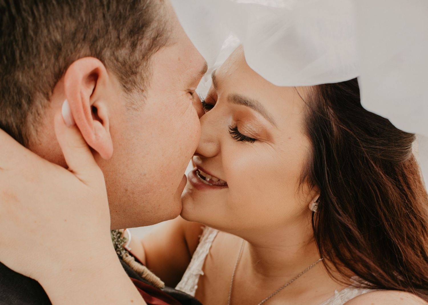 newlyweds almost kissing during photos on their wedding day