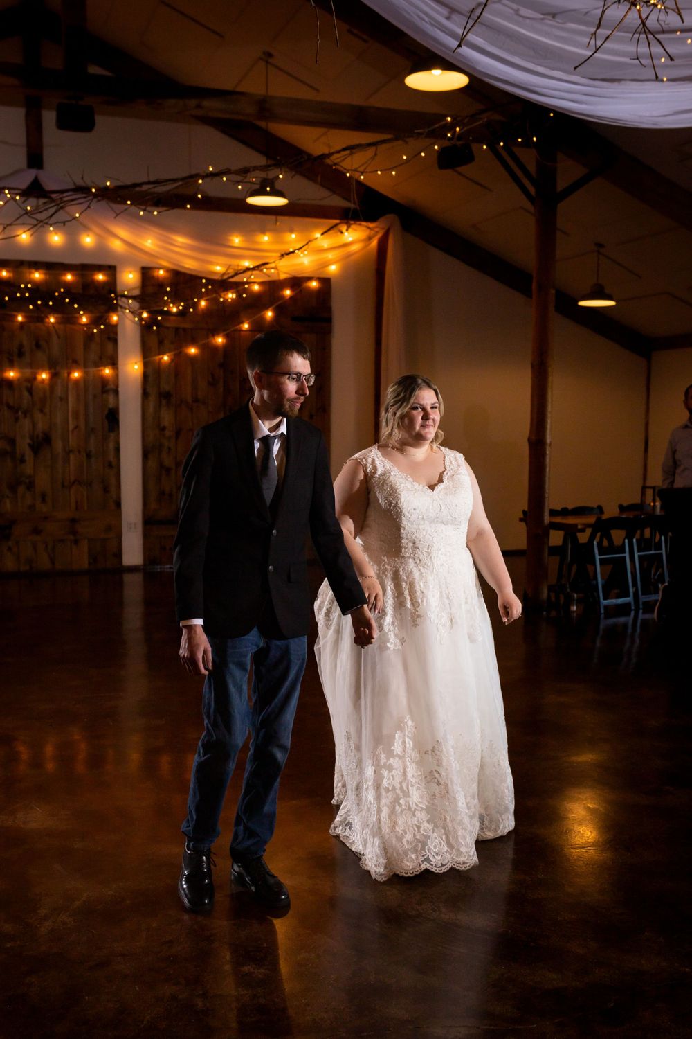 An intimate wedding dance scene in a barn-style venue decorated with warm string lights.
Janesville, WI
Brodhead, WI