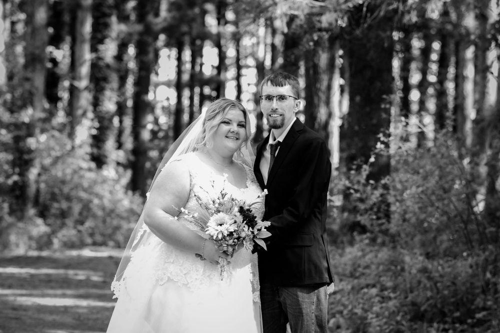A black and white wedding portrait captured in a serene forest setting.
Janesville, WI
Brodhead, WI