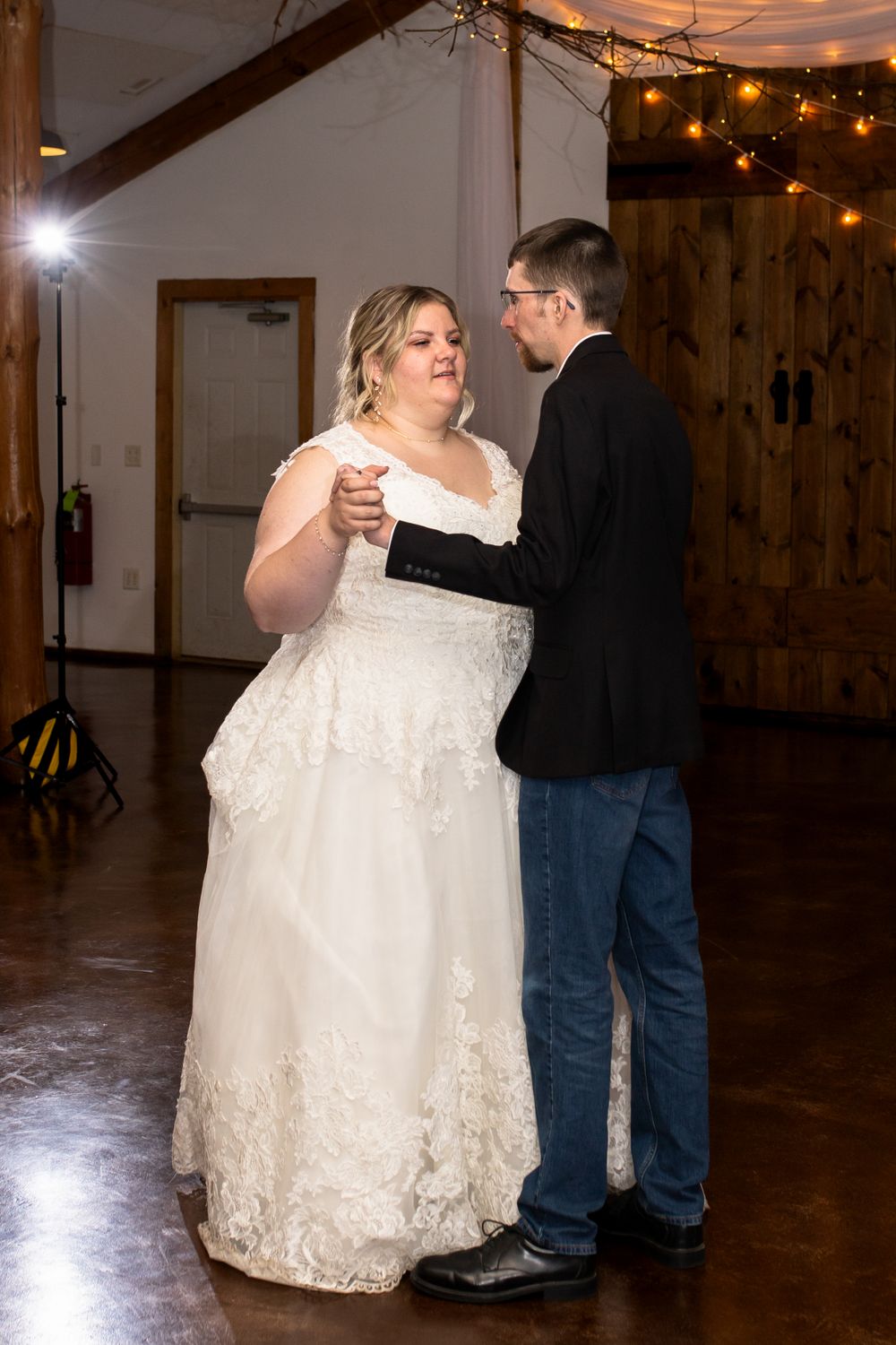 A tender first dance moment captured in a rustic venue with string lights overhead.
Janesville, WI
Brodhead, WI