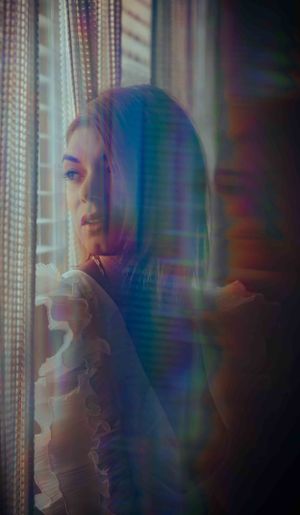 Atmospheric portrait using prismatic light and reflections for a dreamlike quality.