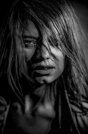 Dramatic black and white portraits with hair movement creating abstract shapes.