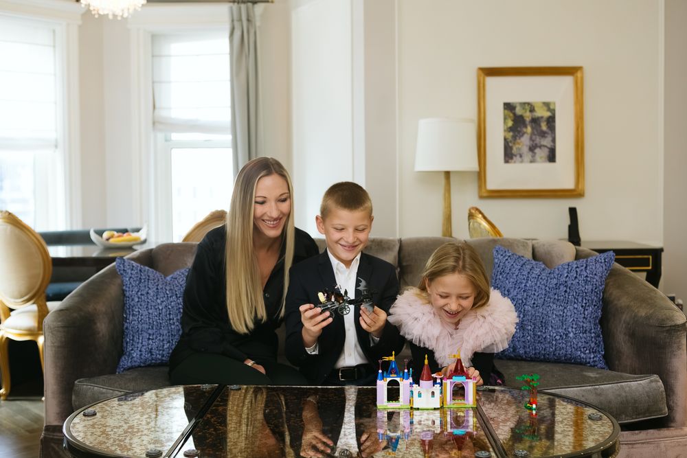 Mom and her kids playing in Plaza Hotel suite, photo by NYC Family Photographer Paula Ortiz