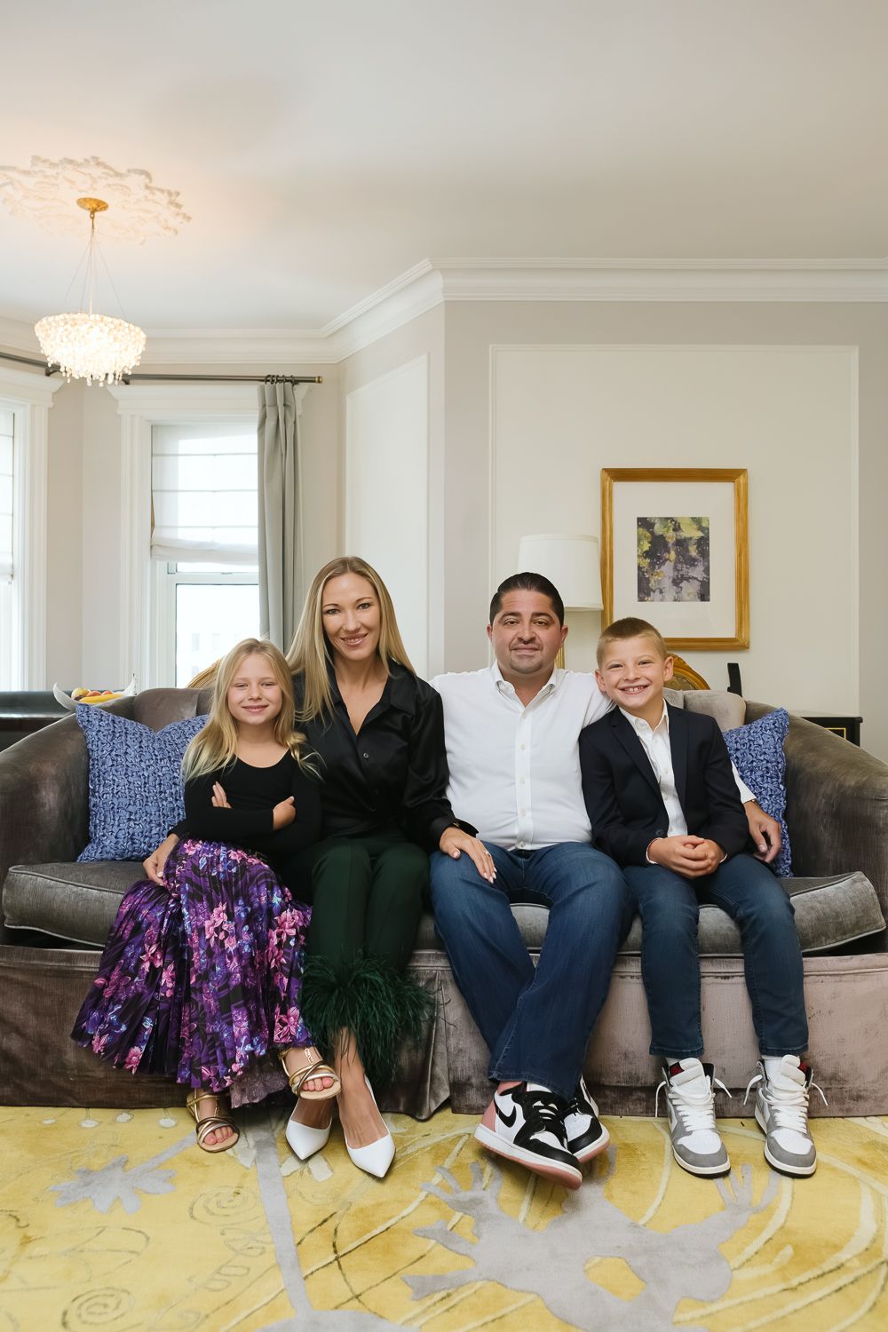 Family of four on the suite's couch at Plaza Hotel, photo by Paula Ortiz NYC Family Photographer