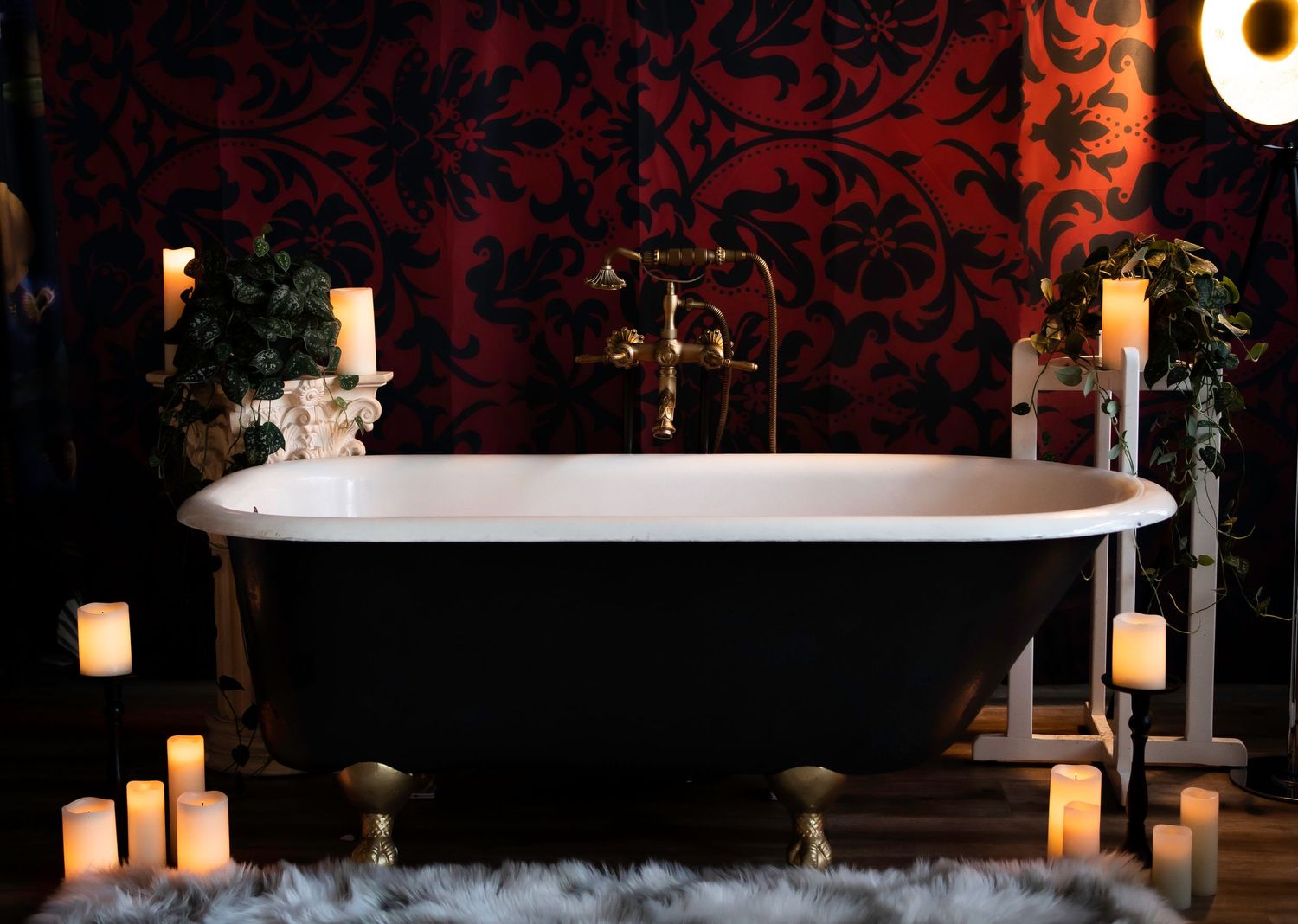 bathtub with gold feet and red background
