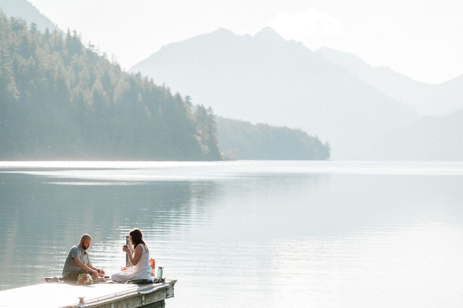 bride and groom eating breakfast on dock during their Lake Crescent elopement.
