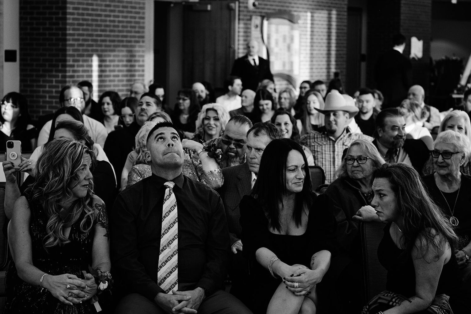 Pensive guests waiting for ceremony - Oshkosh, Wisconsin Wedding Photography.