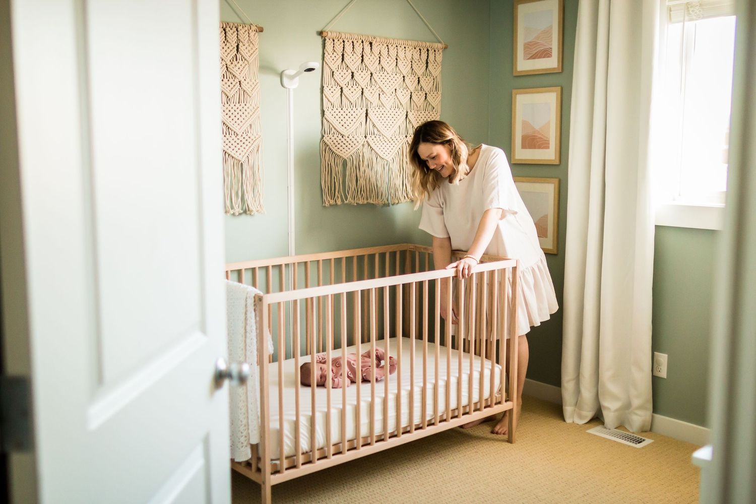 At-home newborn photos in Calgary AB: Sage green boho nursery for baby girl