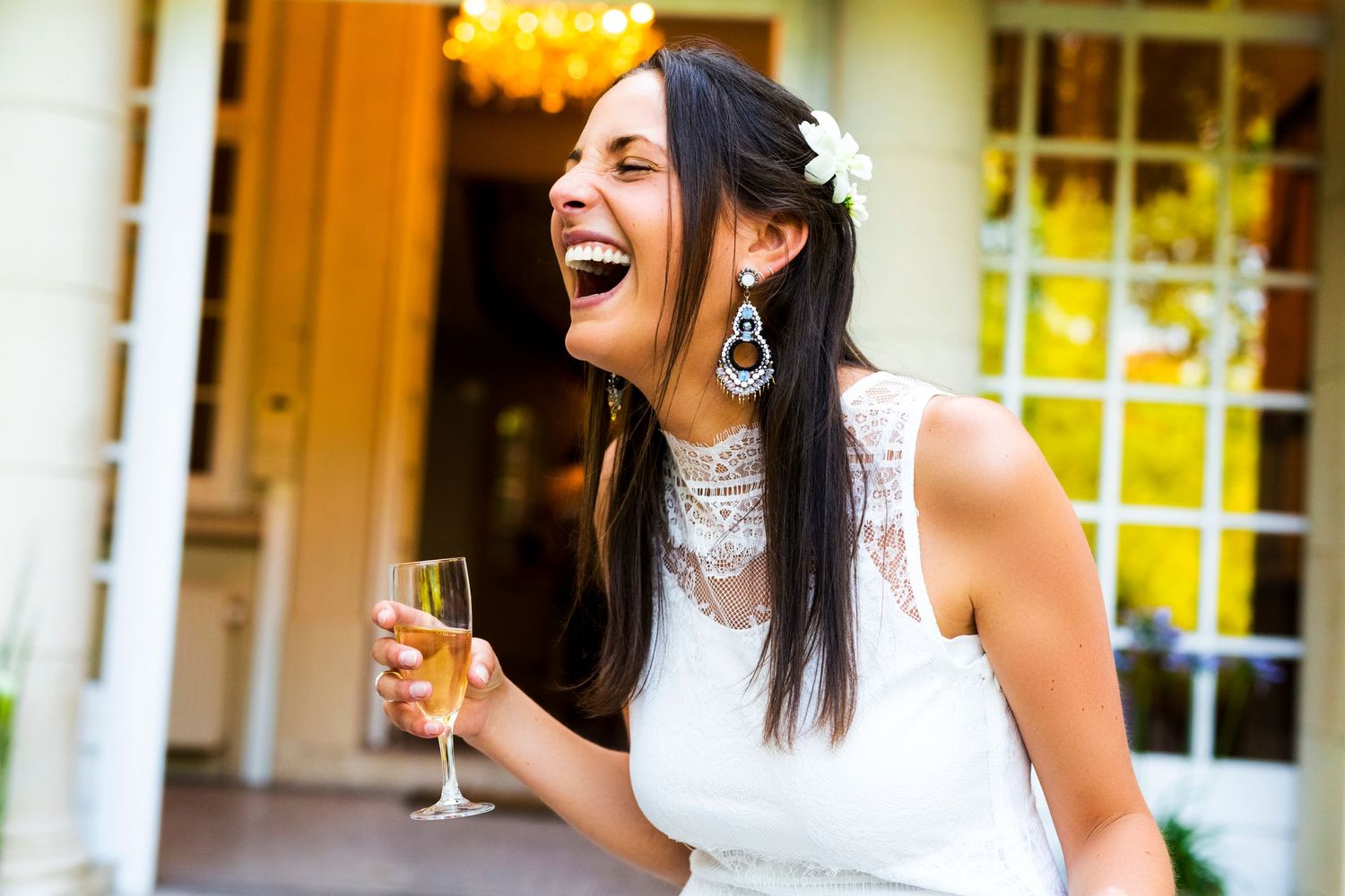 A joyful moment at a wedding celebration with champagne and laughter.