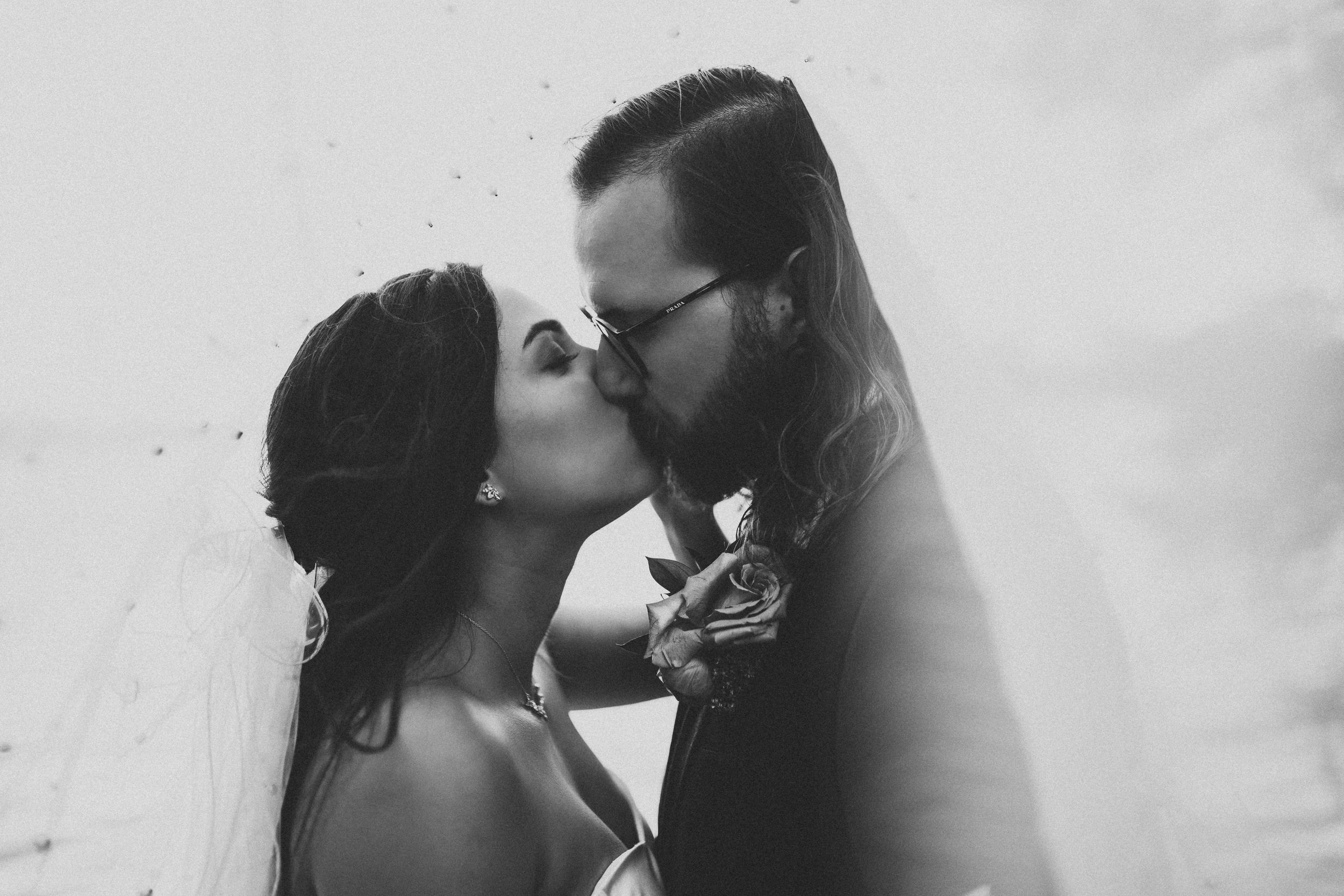 Black and white romantic wedding portrait of couple sharing intimate moment.