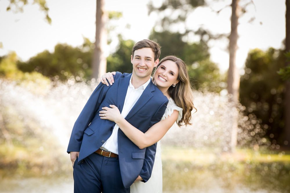 Joyful wedding portraits captured in golden afternoon light among trees.
