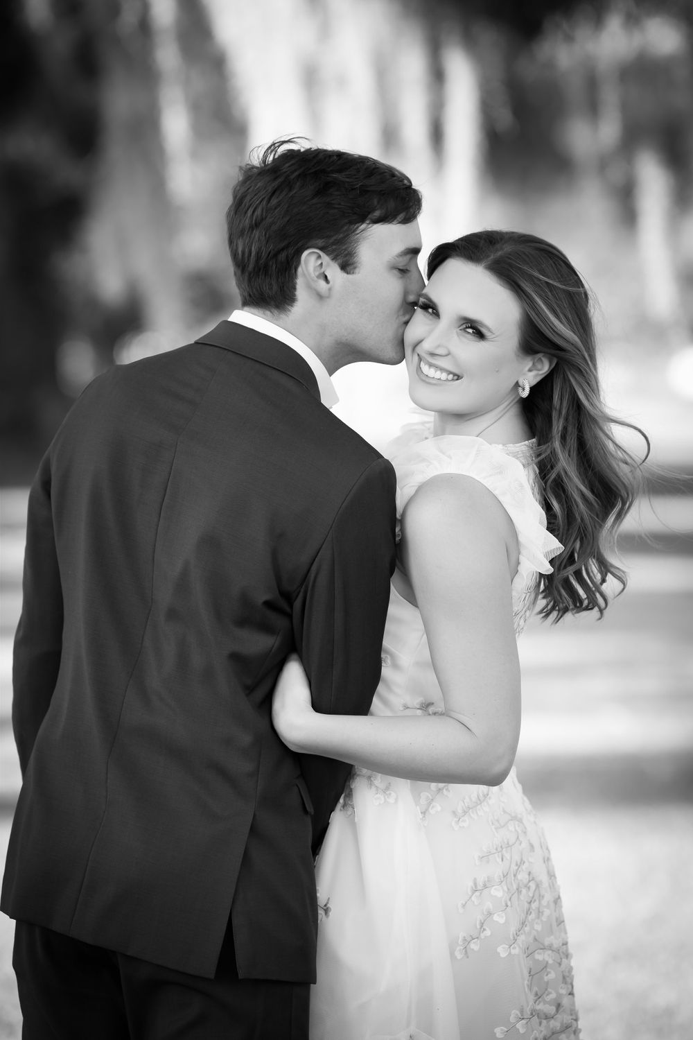 Black and white wedding portraits showing tender moments between newlyweds.