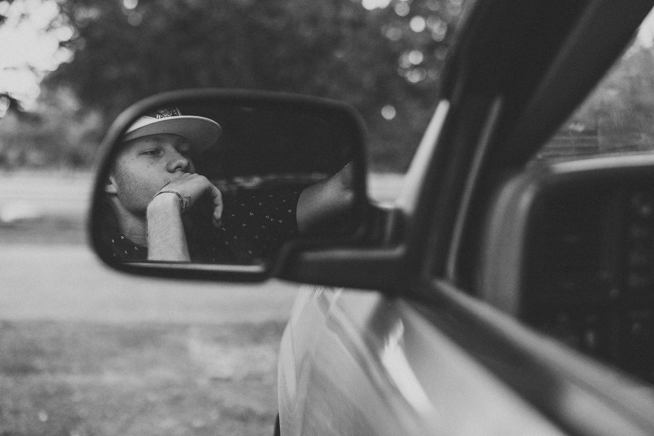 Series of black and white photos capturing intimate moments through a car window.