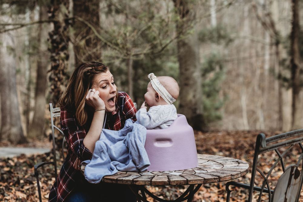 A candid outdoor moment captured during playtime on a metal patio set.