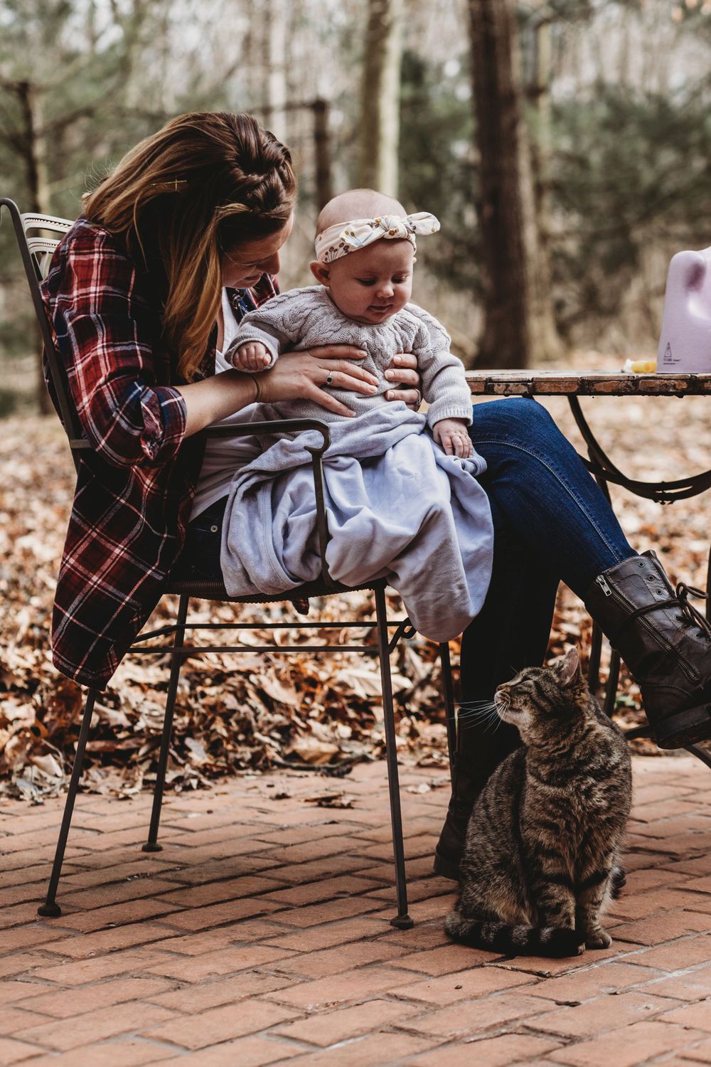 An outdoor moment on a brick patio with a friendly tabby cat joining the scene.