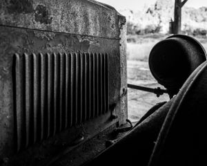 Close-up of old car's radiator grille showing vertical cooling fins.