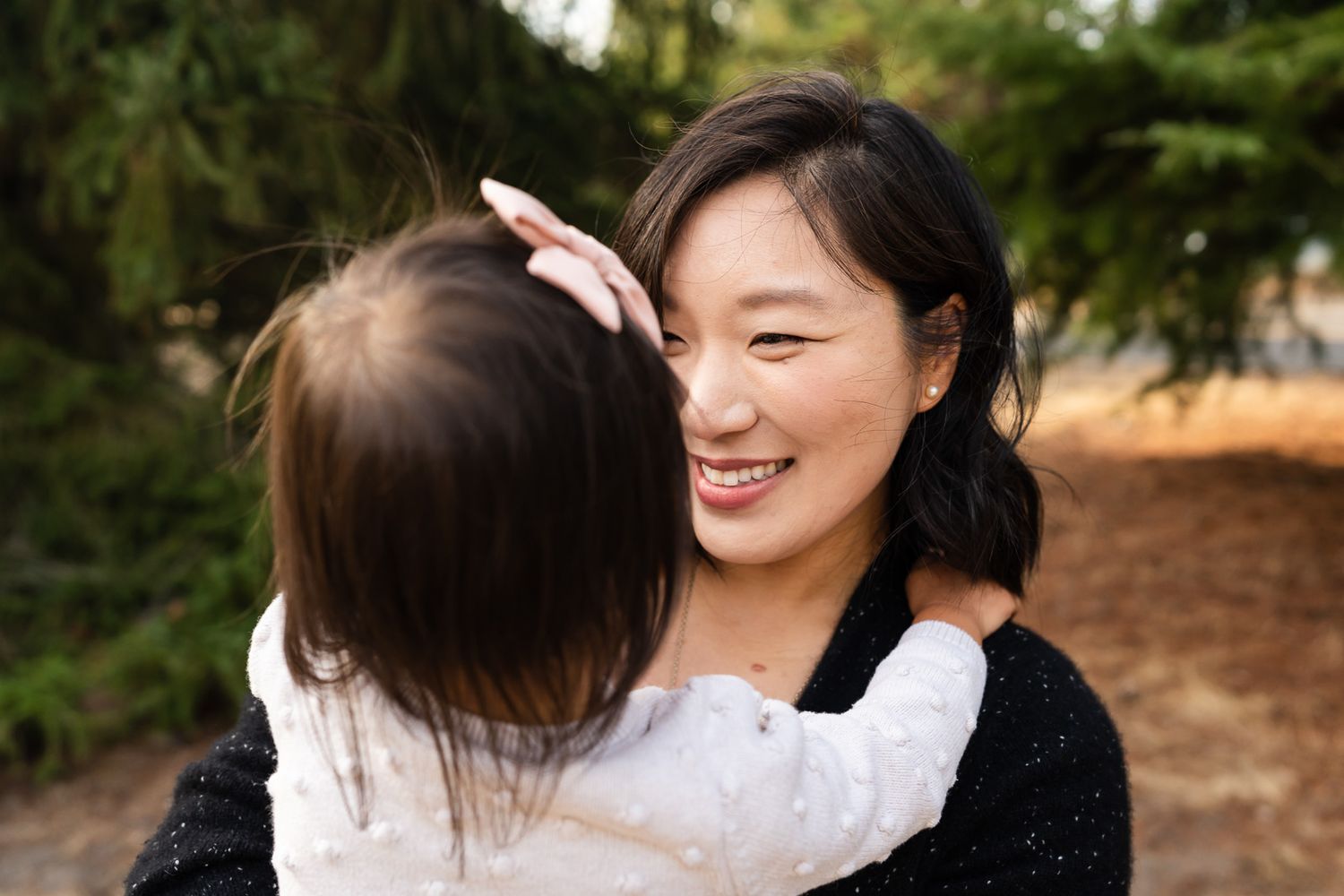 Mother lovingly looks at daughter at Richmond Beach Saltwater Park.