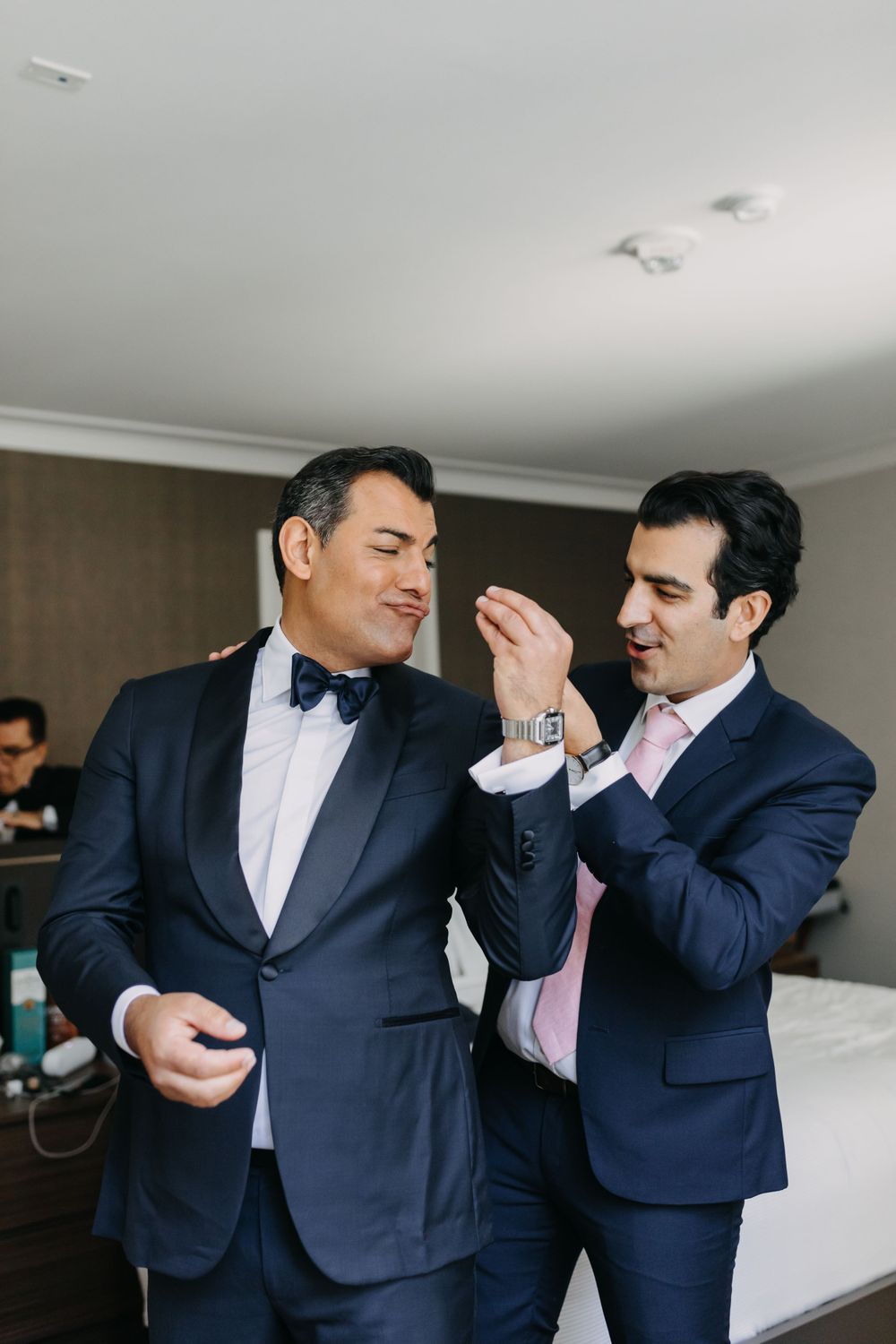 Two people in formal attire sharing a lighthearted moment.
